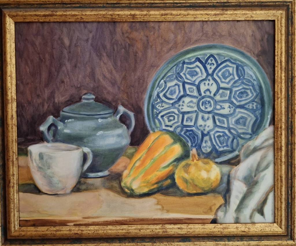 Une peinture représentant une composition de poterie, une assiette ornée de motifs bleus et plusieurs légumes, y compris des courges et une petite citrouille, sur une table.