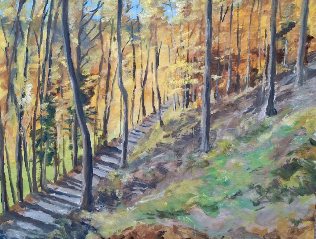 A landscape painting depicting a wooded area during autumn, with tall trees showing golden and orange leaves. A winding path can be seen beside the tree trunks, leading through the forest.